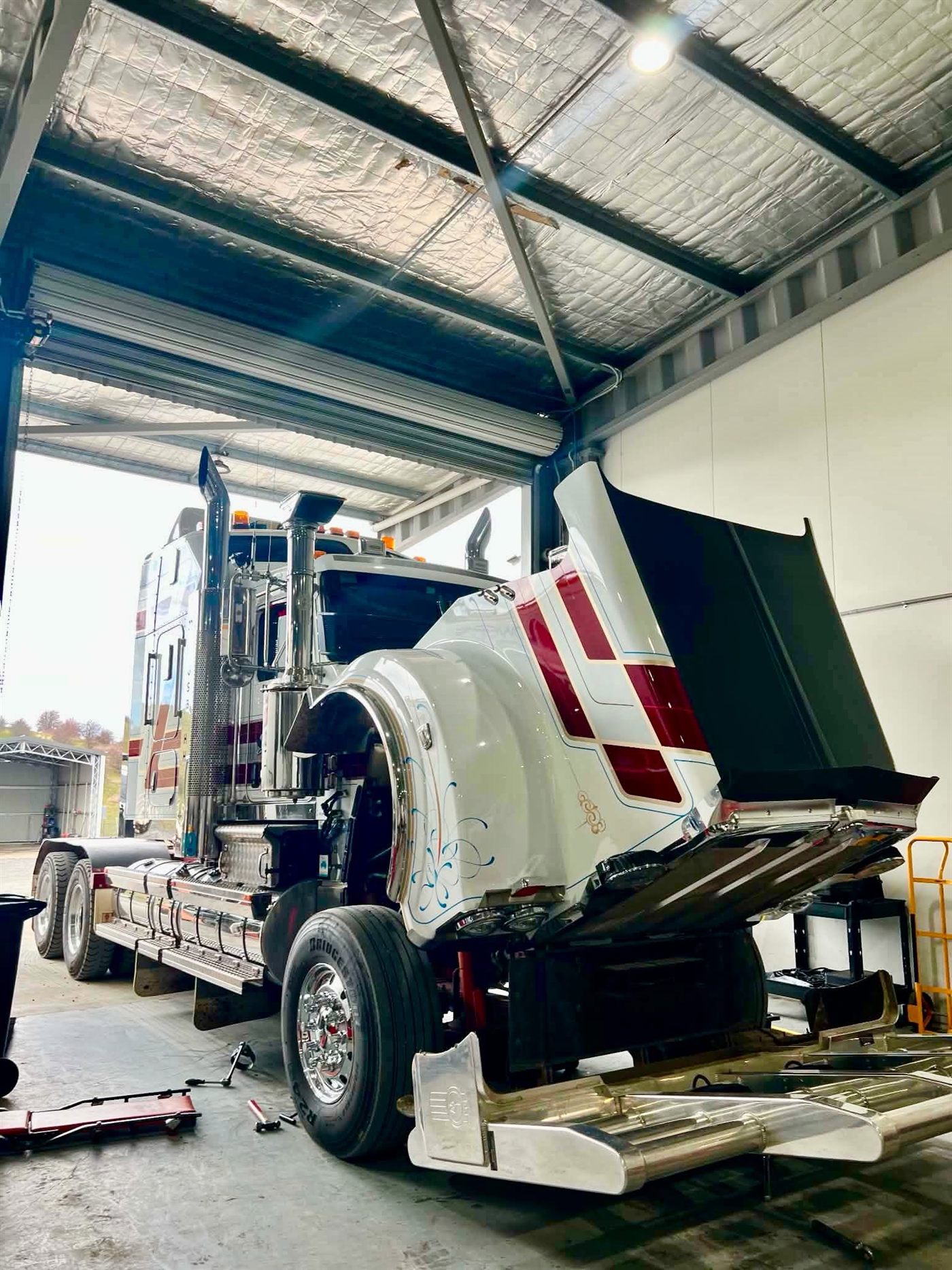 Kenworth with the bonnet tilted forward inside the Frecklington workshop
